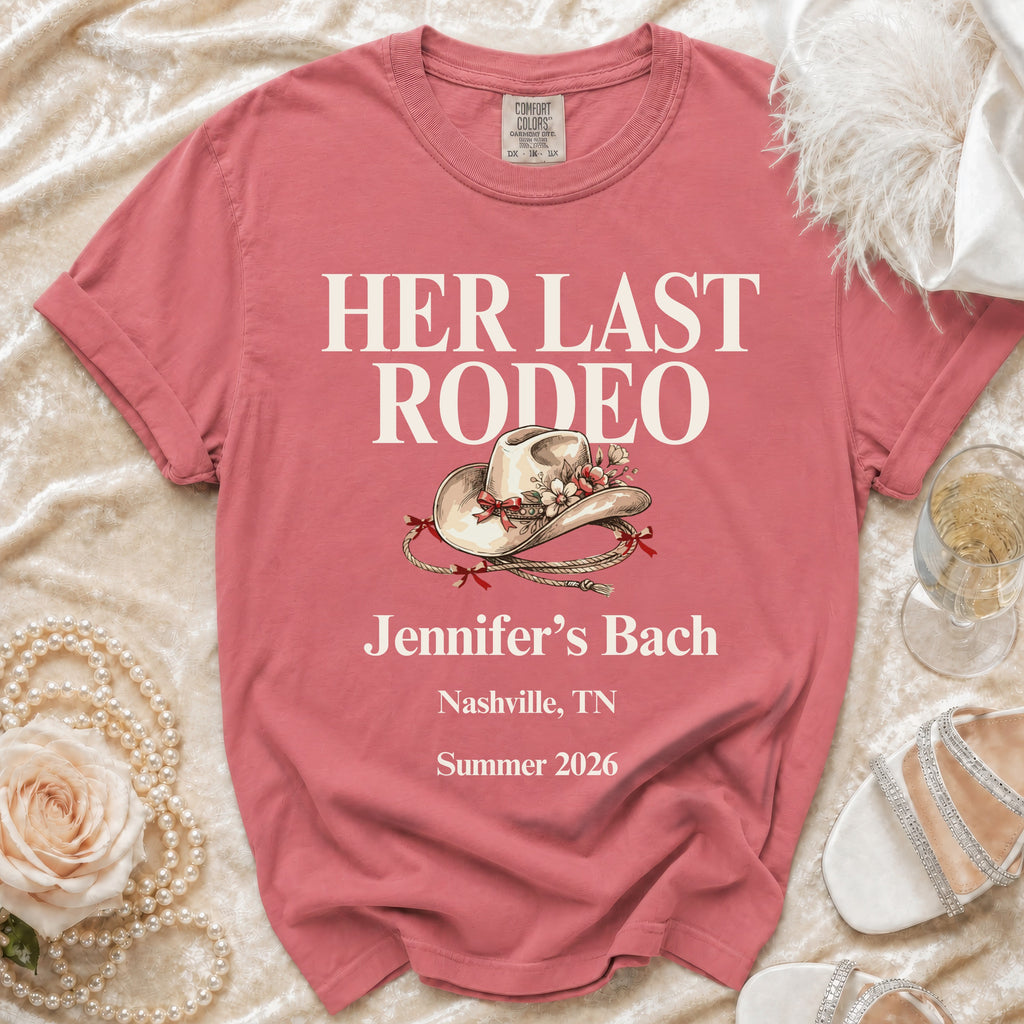 Pink t-shirt with "Her Last Rodeo" text and a cowboy hat.