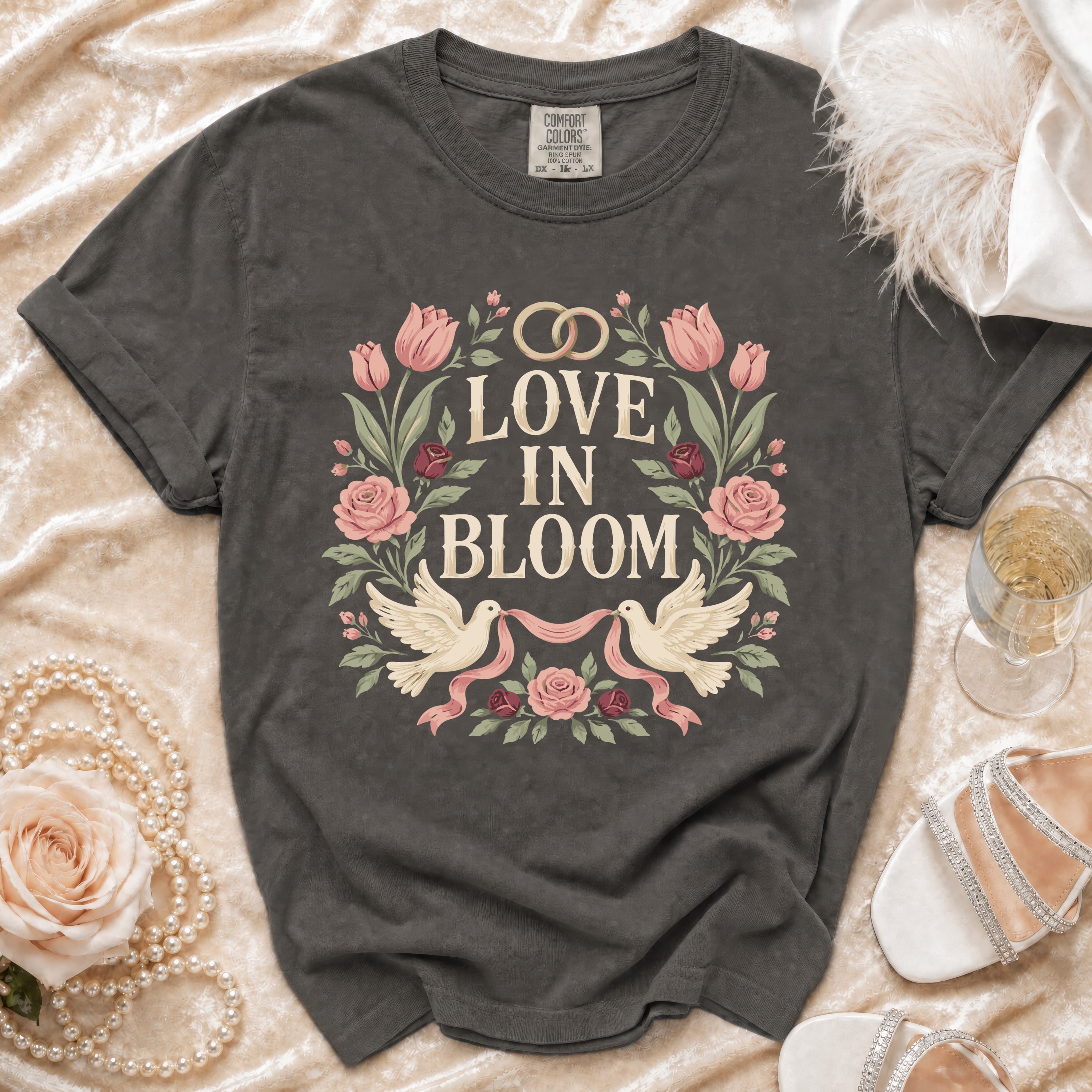 Dark grey t-shirt with "Love in Bloom" text, two doves, and floral design.
