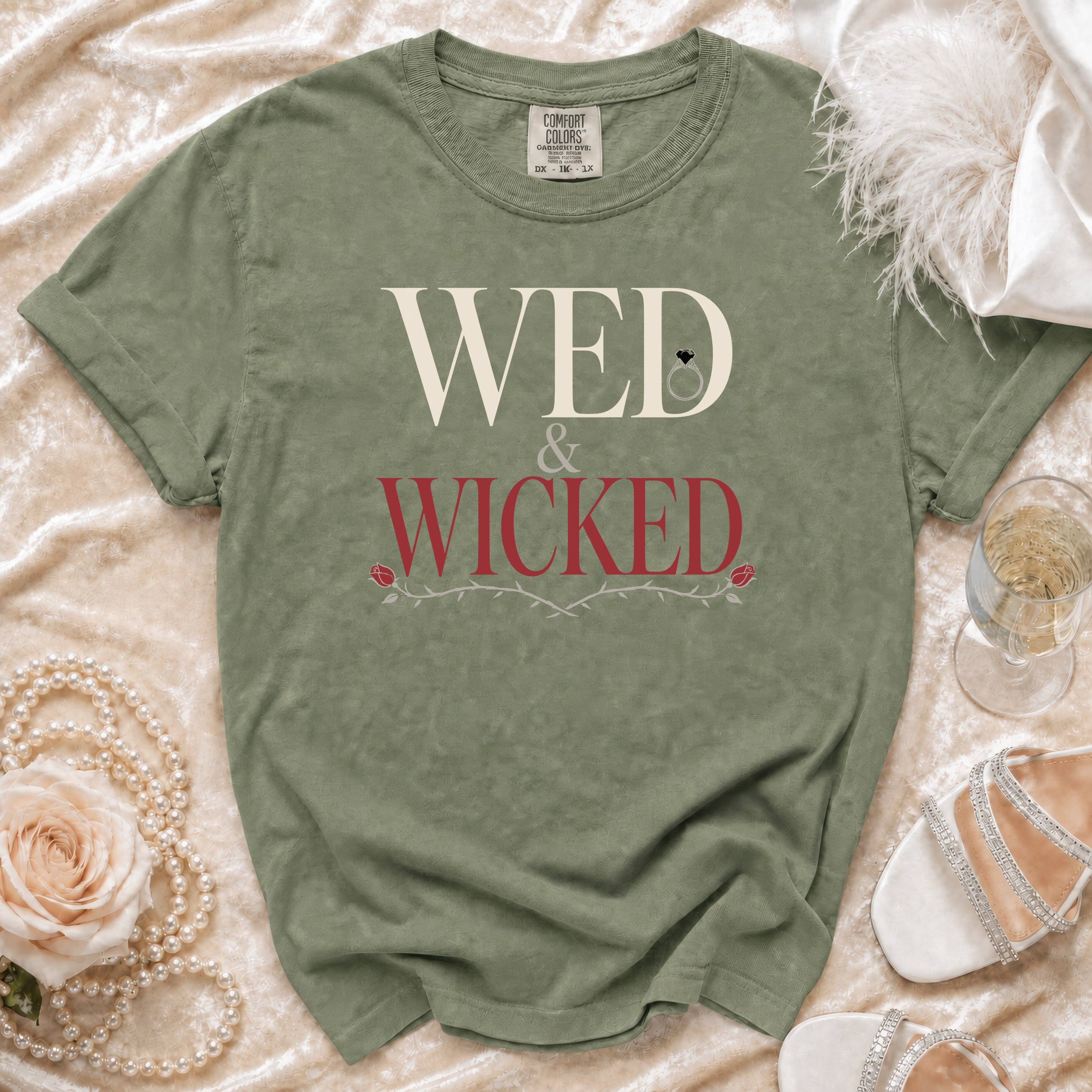 Olive green t-shirt with "WED & WICKED" text and a ring and rose graphic.