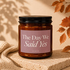 Amber jar candle with "The Day We Said Yes" text and "VOWED" logo.