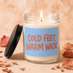 Candle with blue label that reads "COLD FEET, WARM WICK" by VOWED.