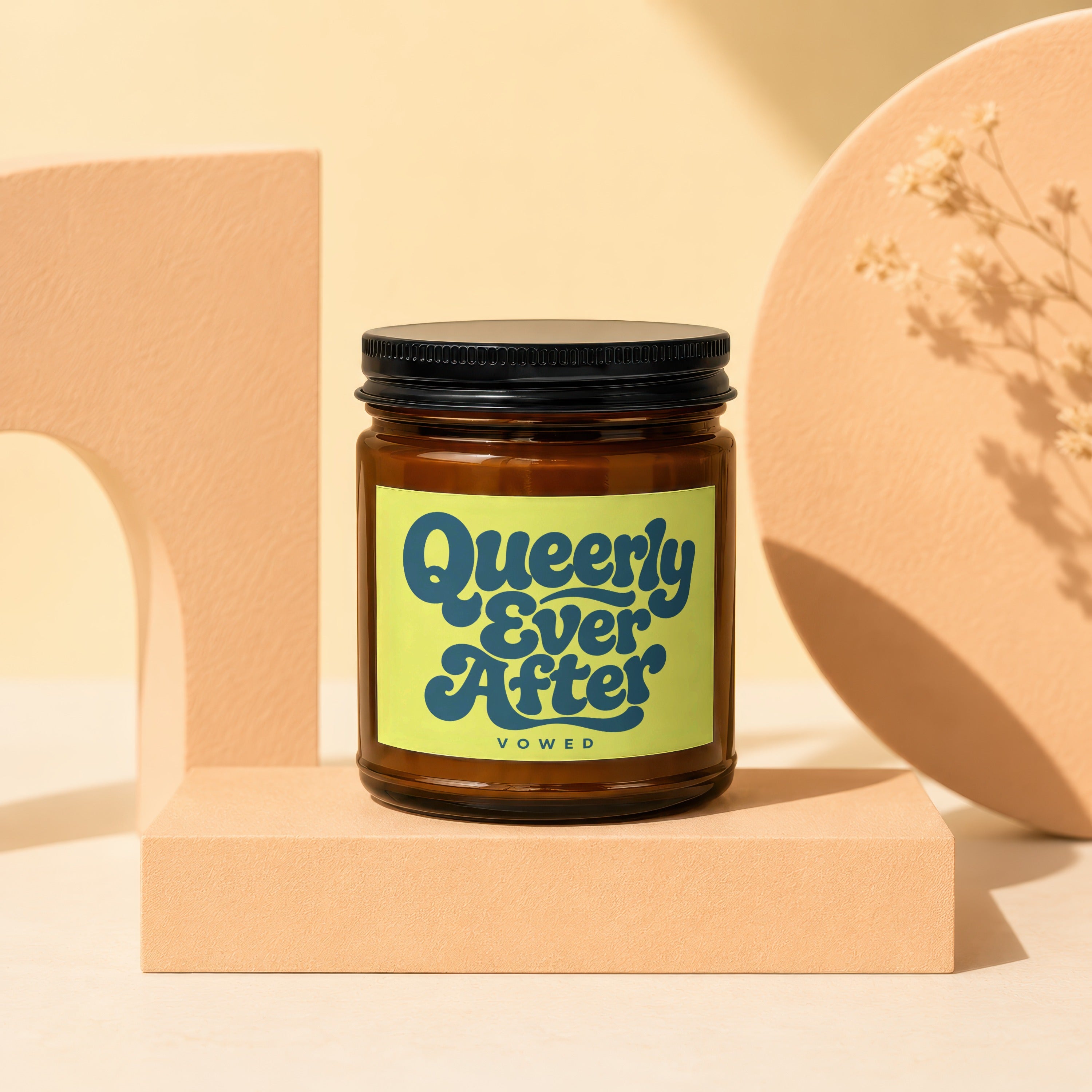 Queerly Ever After Vowed candle in amber glass jar with black lid.