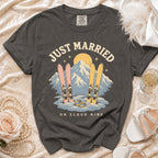 Just Married on Cloud Nine graphic t-shirt with skis, rings, and mountains.