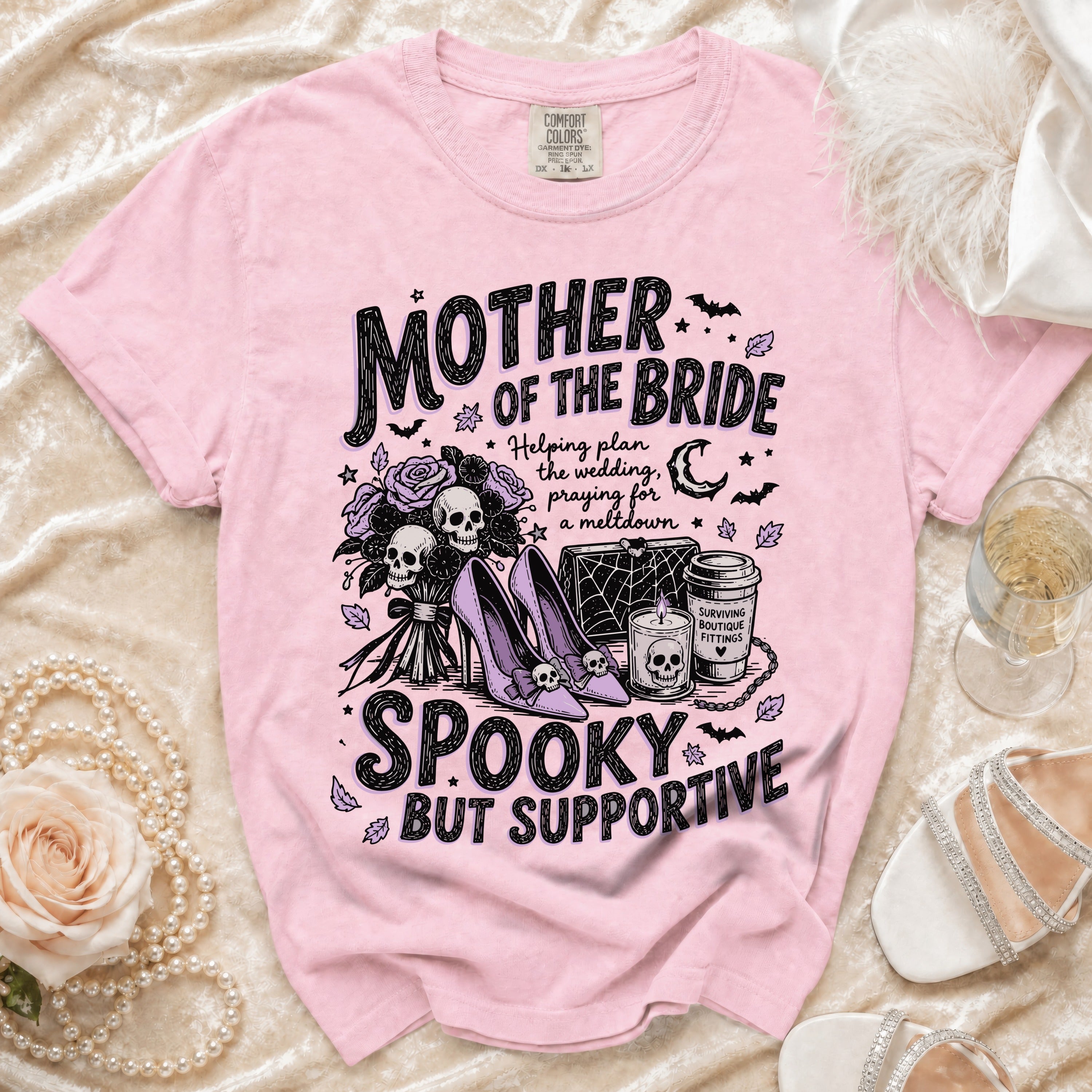 Pink t-shirt with "Mother of the Bride" graphic and skulls, roses, and high heels.