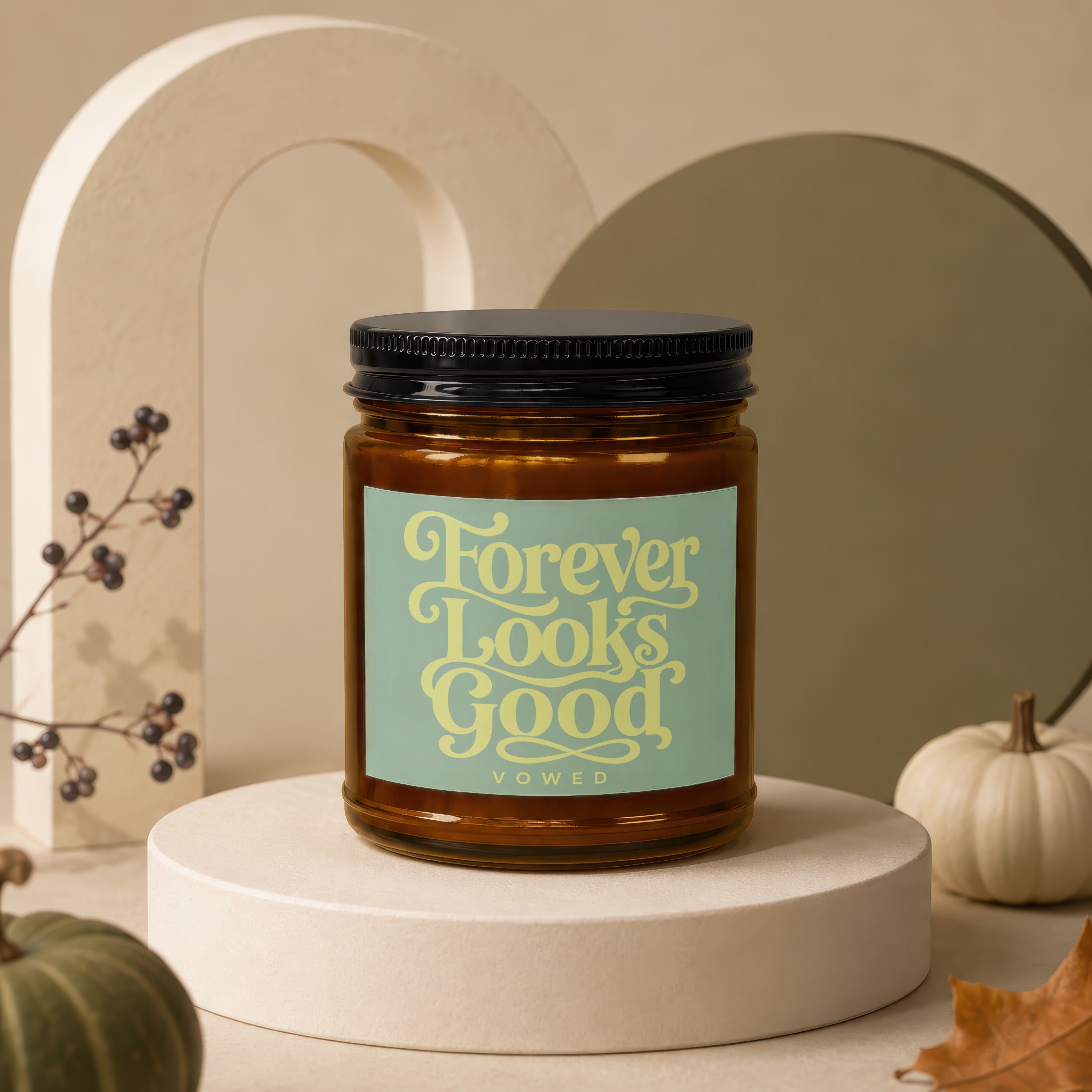 Amber jar candle with a light blue label reading "Forever Looks Good Vowed".