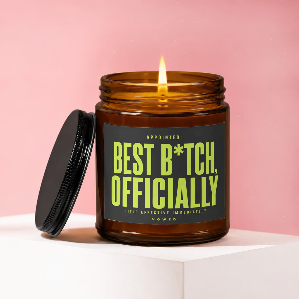 Amber jar candle with lit flame, reads "BEST B*TCH, OFFICIALLY".