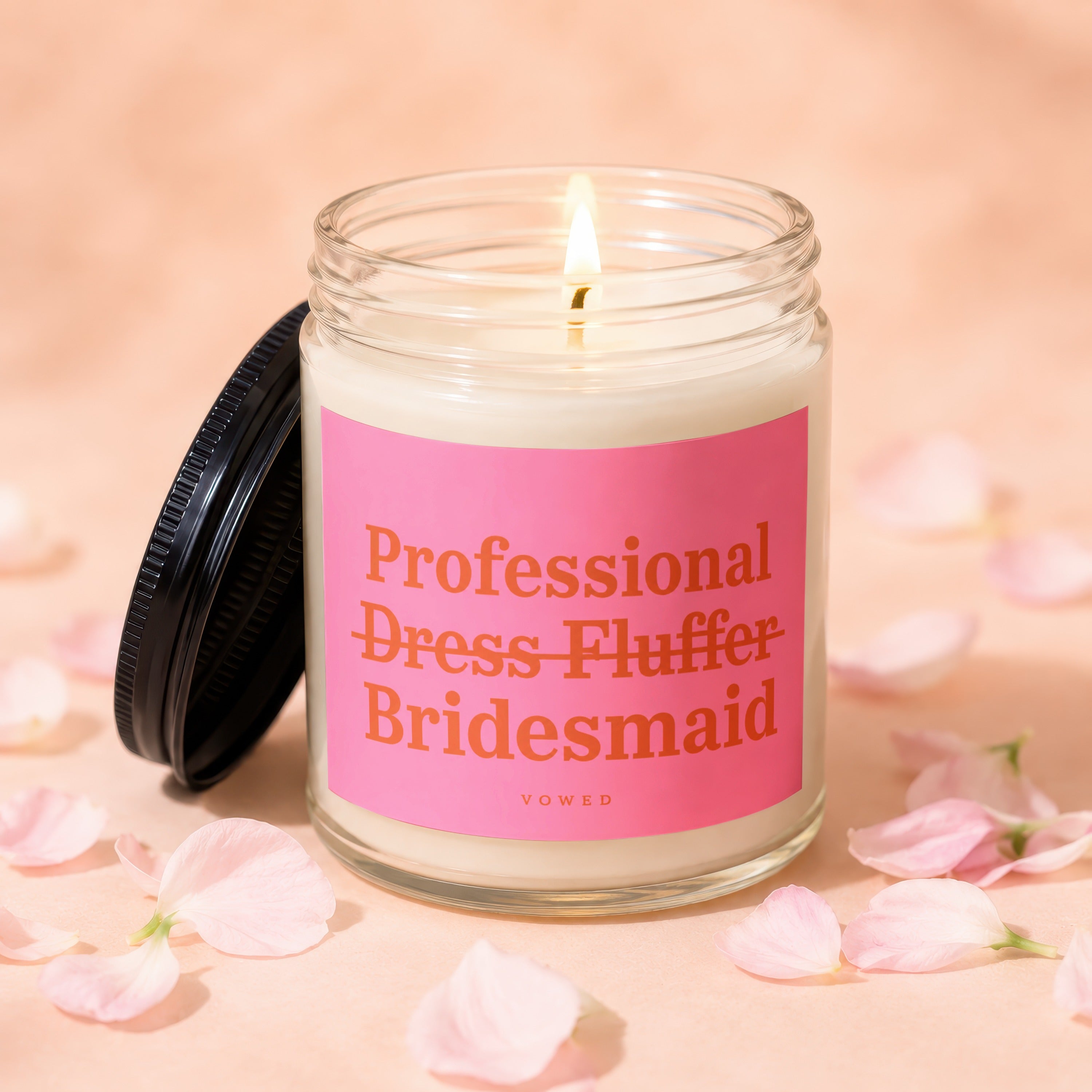 Glass jar candle with pink label reading "Professional Dress Fluffer Bridesmaid."