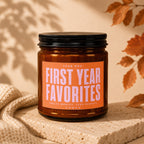 Amber jar candle labeled "First Year Favorites" with detailed text at the bottom.