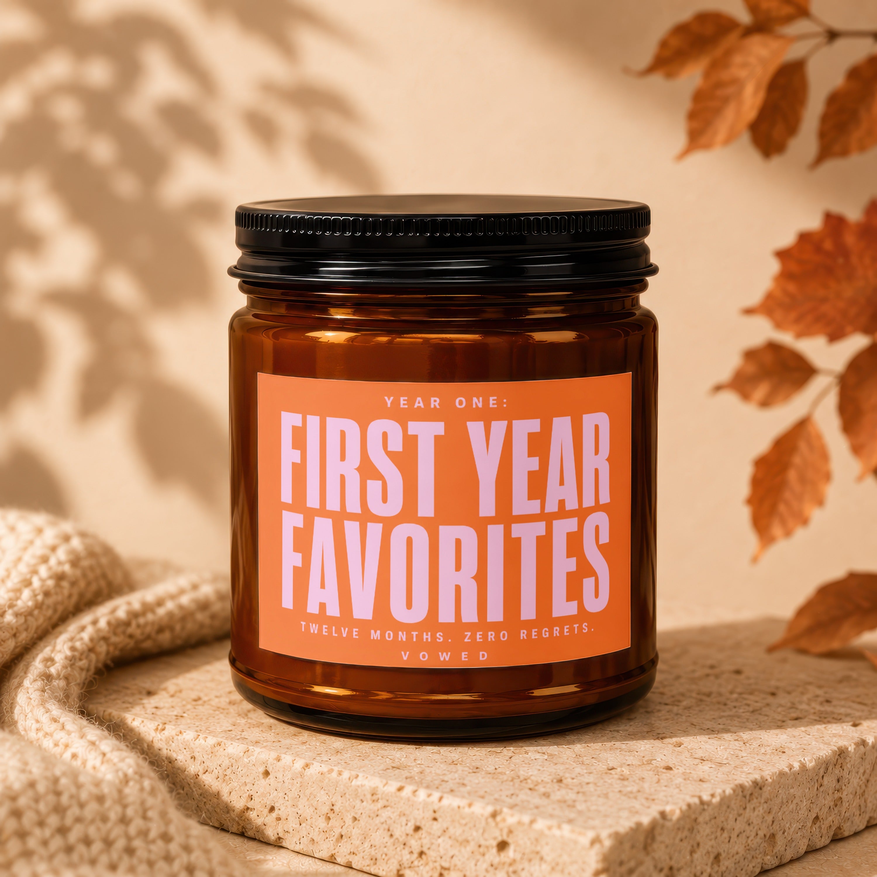 Amber jar candle labeled "First Year Favorites" with detailed text at the bottom.