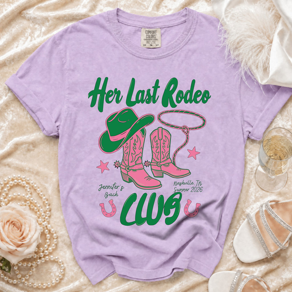 Lavender t-shirt with "Her Last Rodeo" text, cowboy hat, boots, and lasso.