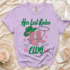 Lavender t-shirt with "Her Last Rodeo" text, cowboy hat, boots, and lasso.