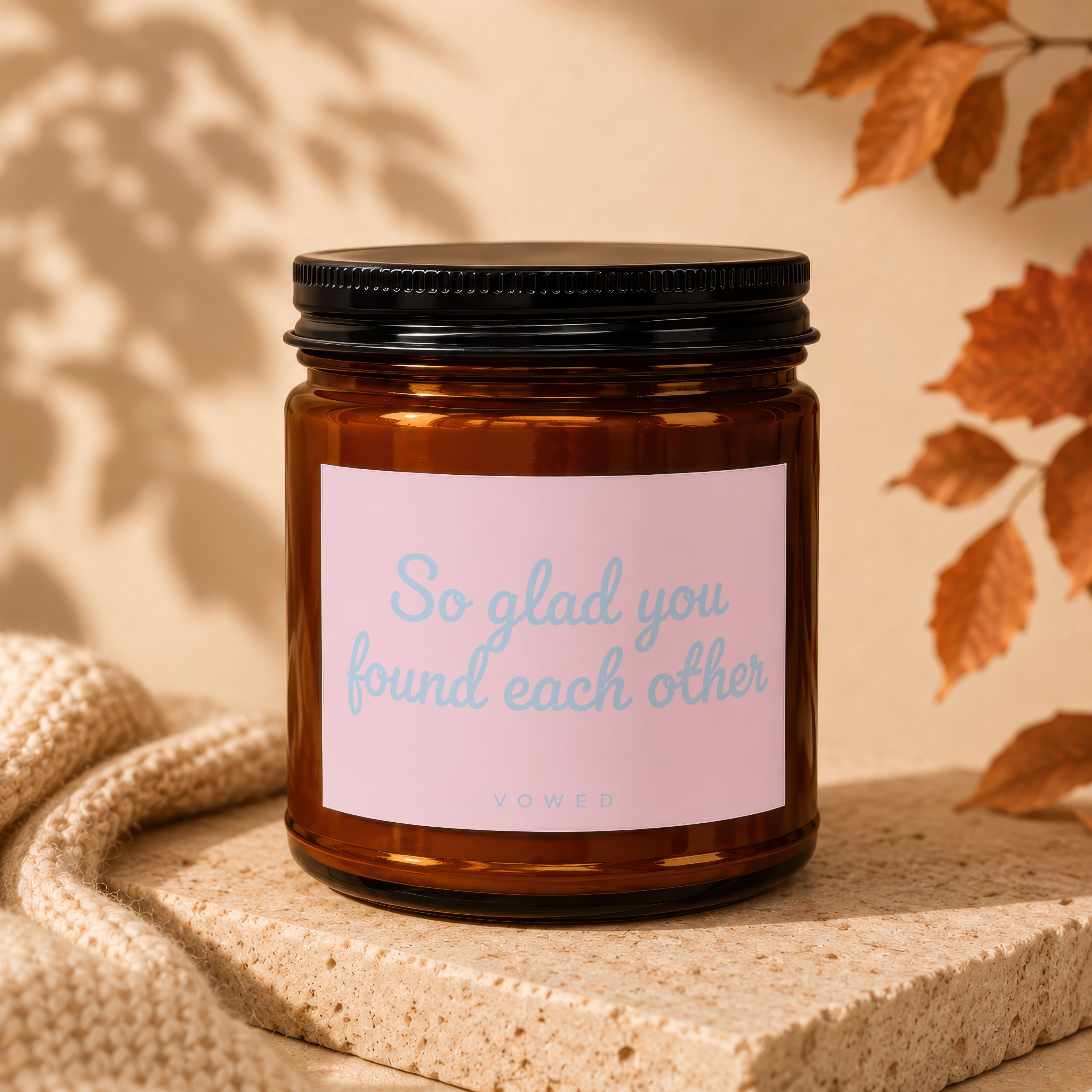Amber jar candle with pink label reading "So glad you found each other VOWED".