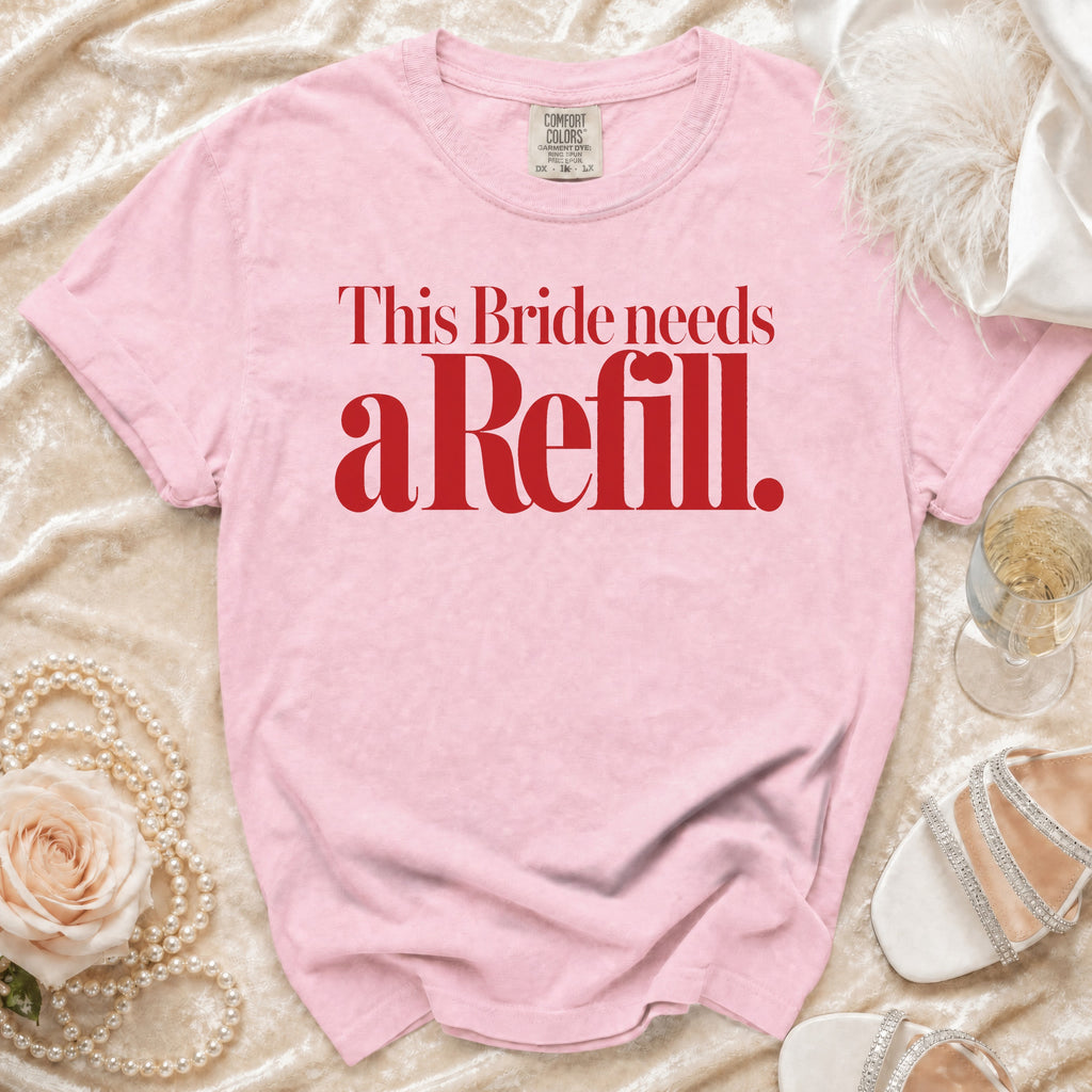 Pink t-shirt with red text reading "This Bride needs a Refill."
