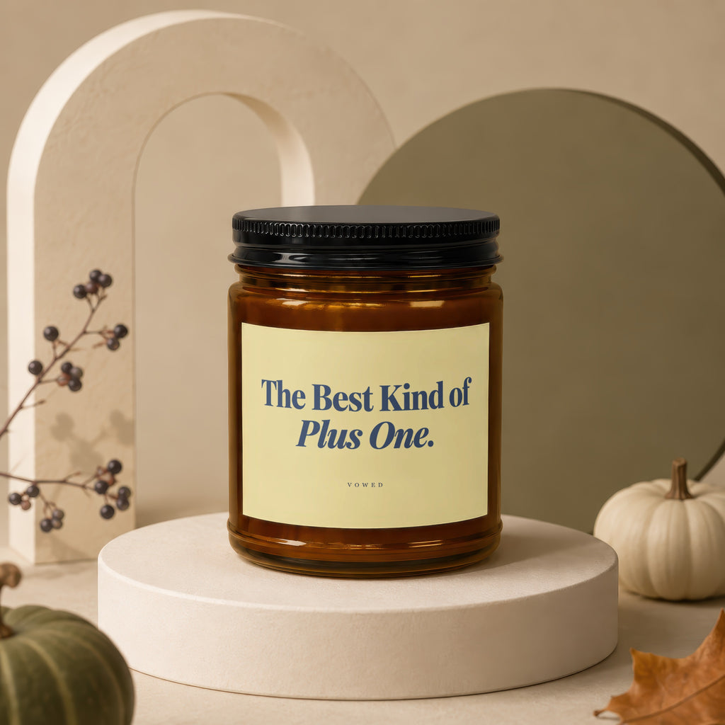 Amber candle with black lid, text reads "The Best Kind of Plus One."