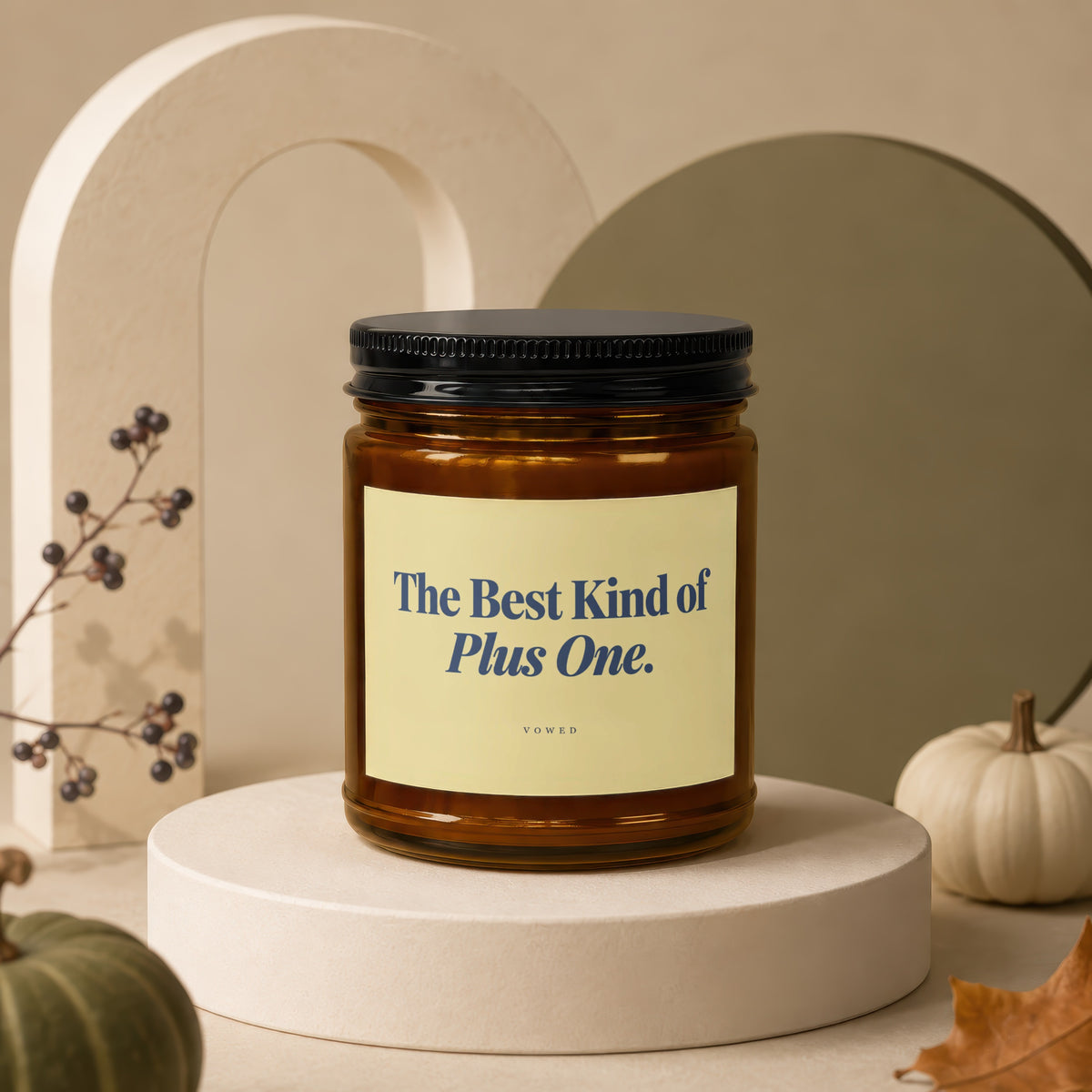 Amber candle with black lid, text reads "The Best Kind of Plus One."