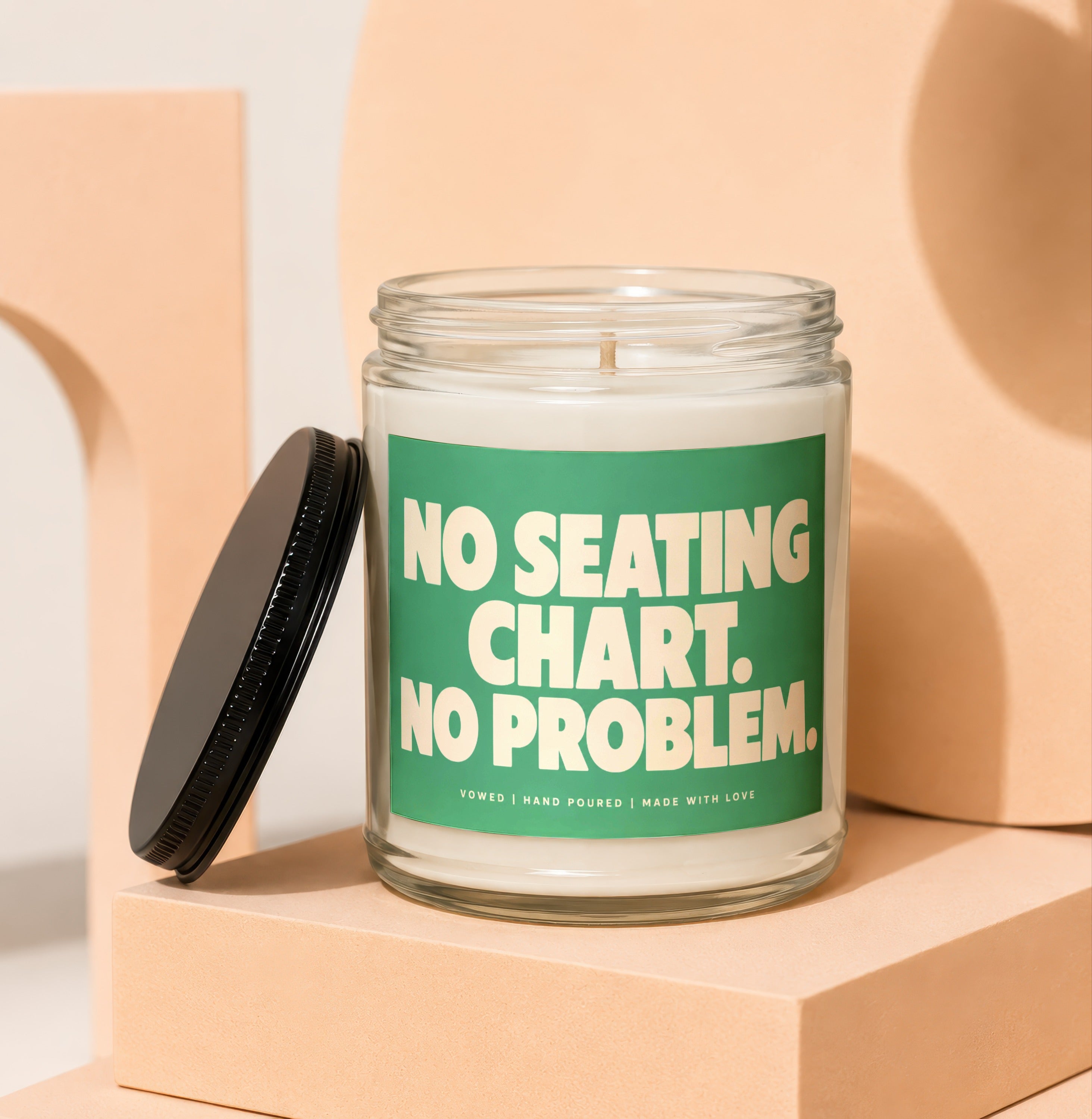 Candle with green label reading "NO SEATING CHART. NO PROBLEM."