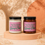 Two candles with pink labels that read "The Yes Heard Round the Group Chat".