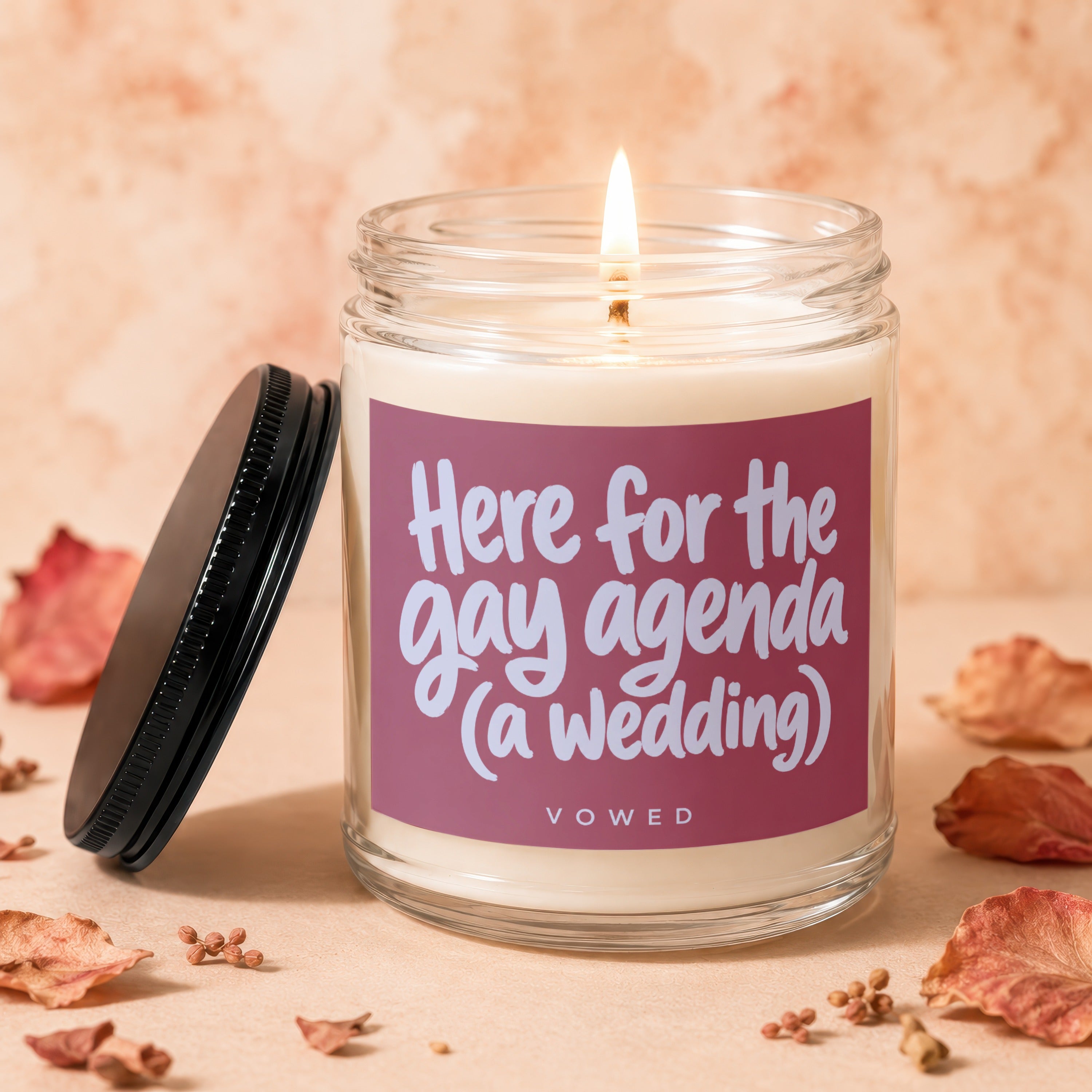 Candle with text "Here for the gay agenda (a wedding)" and "VOWED".