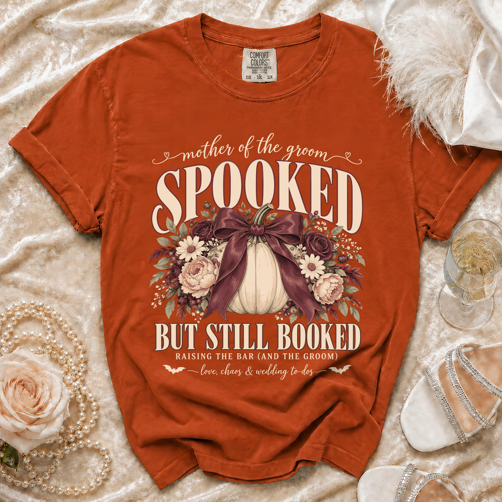 Orange t-shirt with "Mother of the Groom Spooked But Still Booked" graphic.