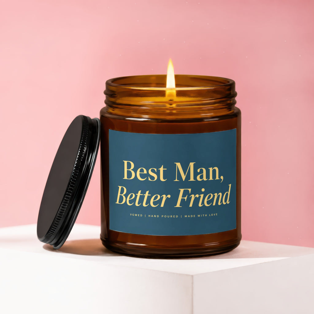 Amber jar candle with lit wick and black lid, says "Best Man, Better Friend".