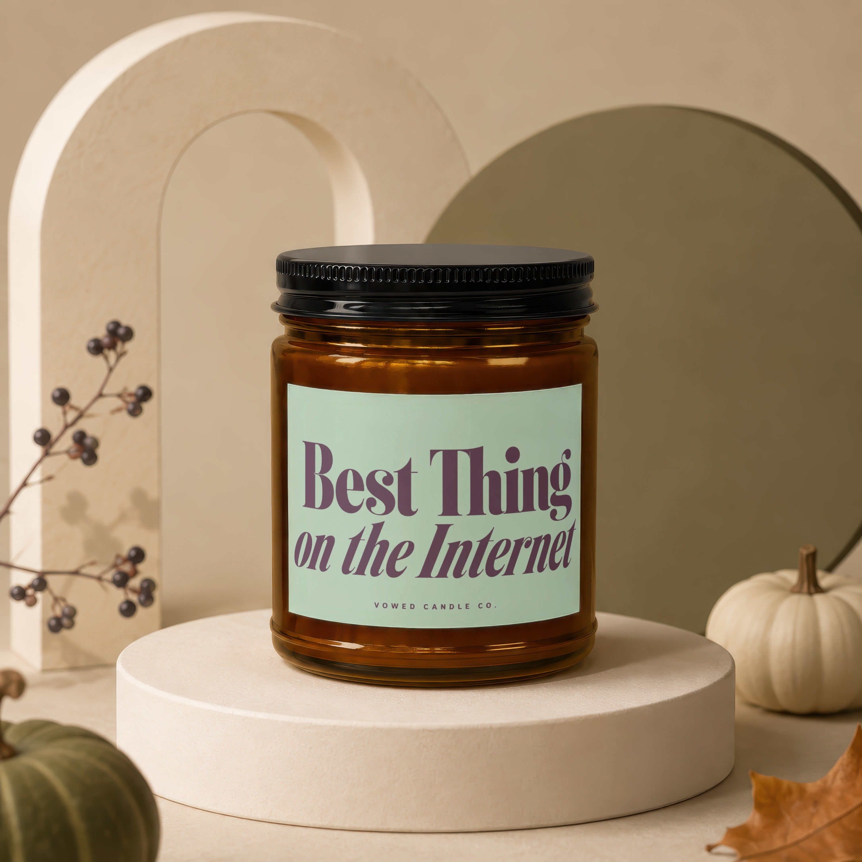 Amber glass candle with black lid labeled "Best Thing on the Internet."