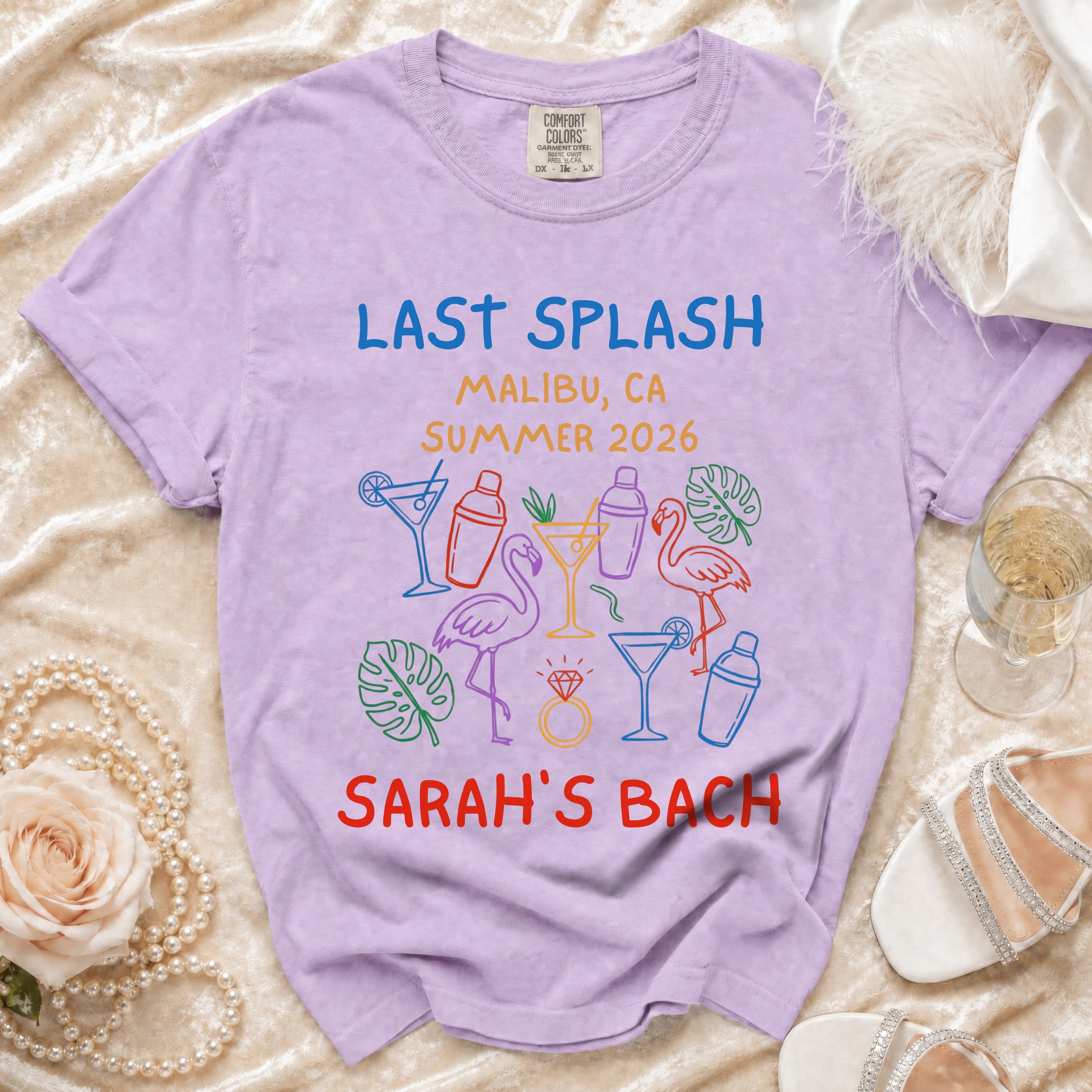 Purple t-shirt with "Last Splash Malibu, CA Summer 2026 Sarah's Bach" and cocktail illustrations.