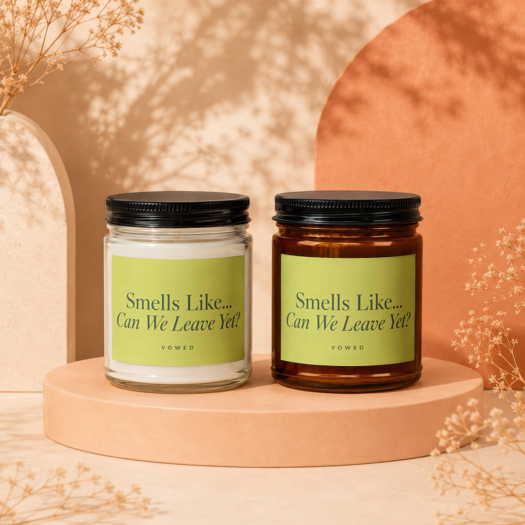 Two candles with "Smells Like... Can We Leave Yet?" labels, one white, one amber.