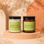 Two candles with "Smells Like... Can We Leave Yet?" labels, one white, one amber.