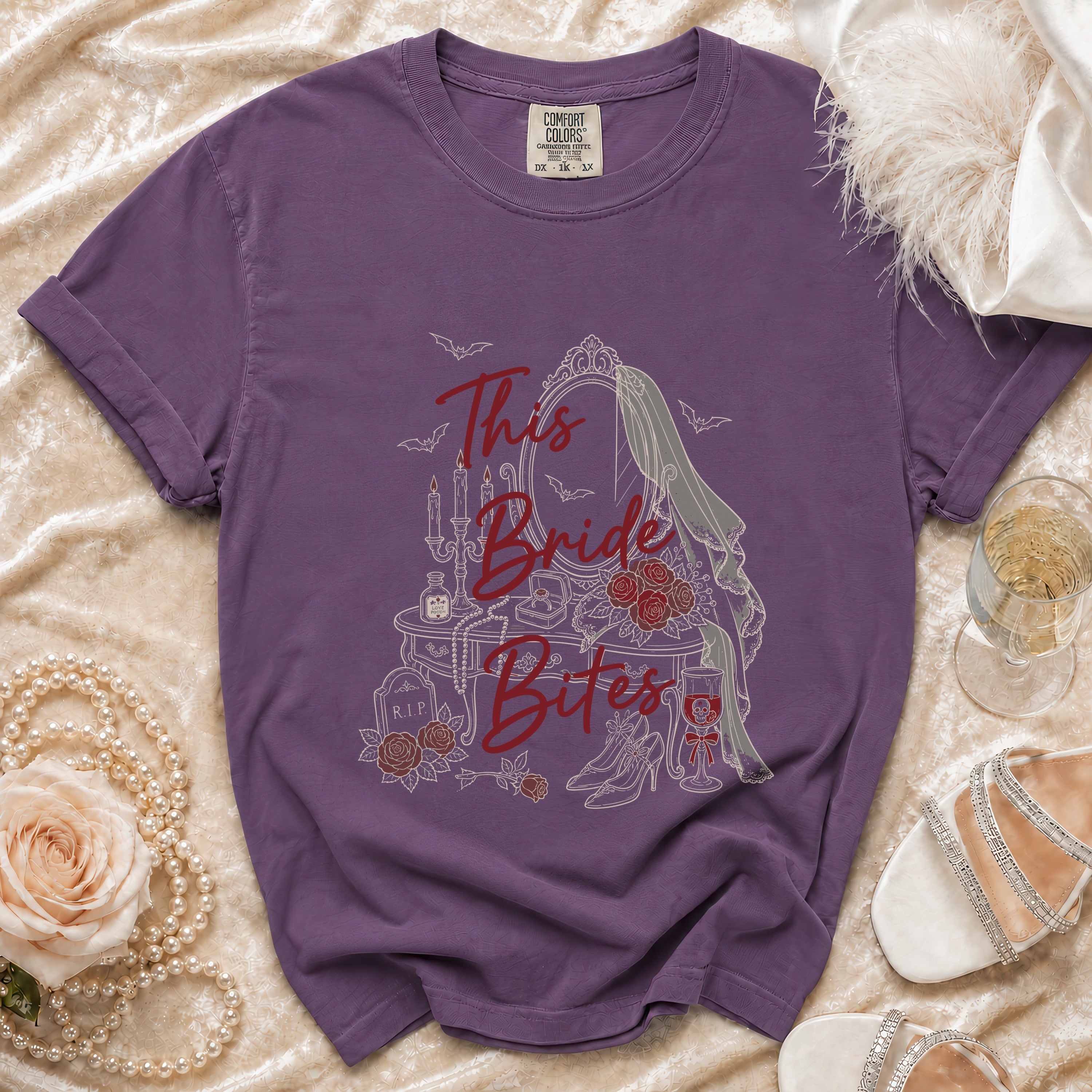 Purple t-shirt with "This Bride Bites" gothic design and vampire bats.