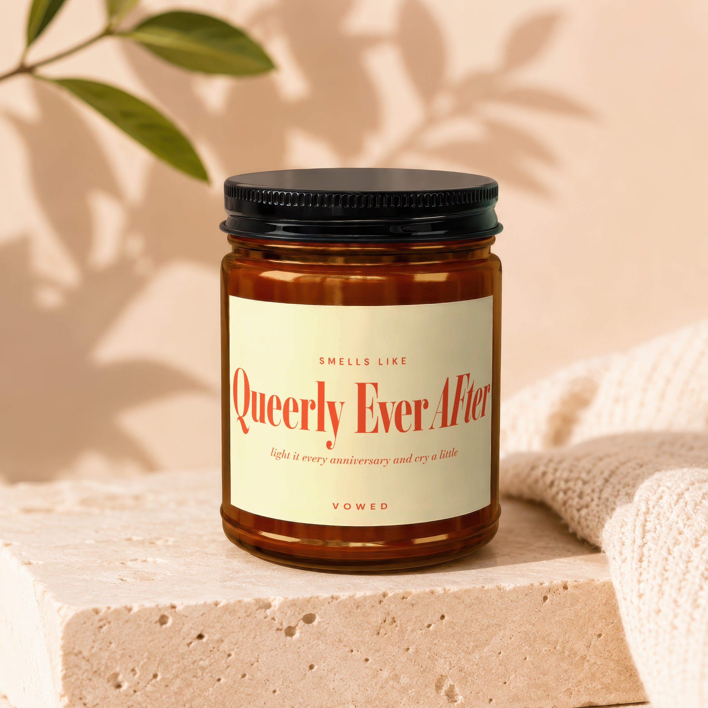 Amber jar candle with "Queerly Ever After" text, "VOWED".