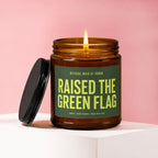 Amber candle with "Raised The Green Flag" text and a lit flame.
