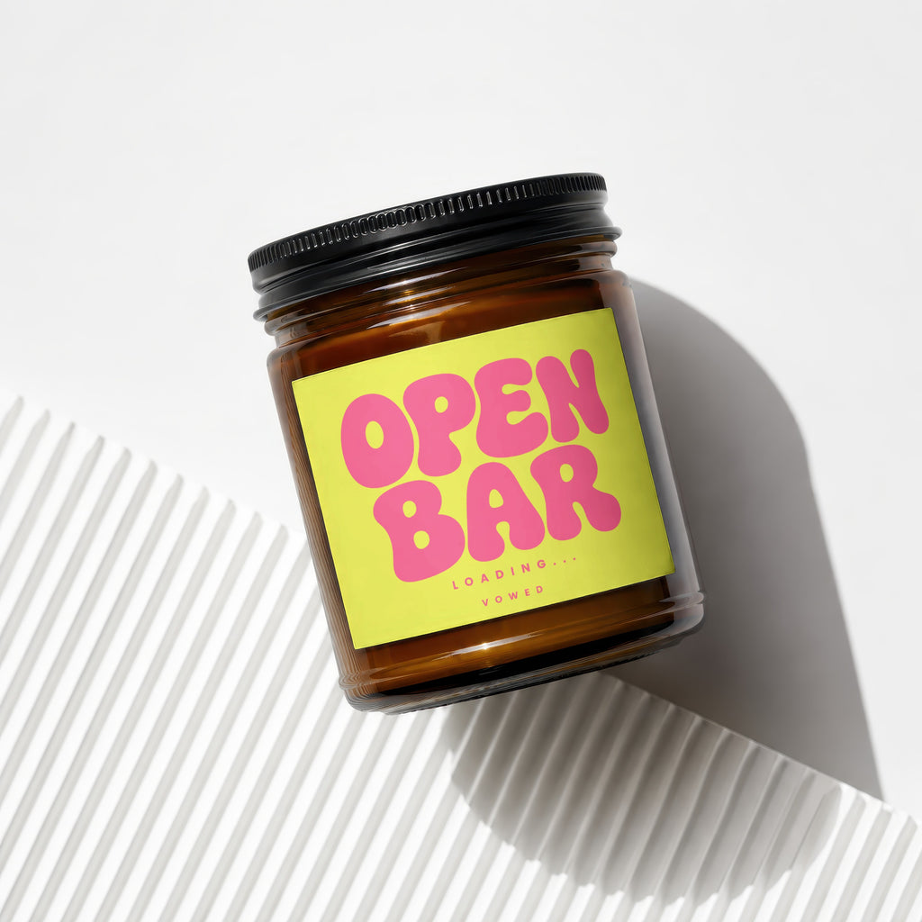Brown glass jar with black lid and yellow label reading "OPEN BAR LOADING... VOWED".