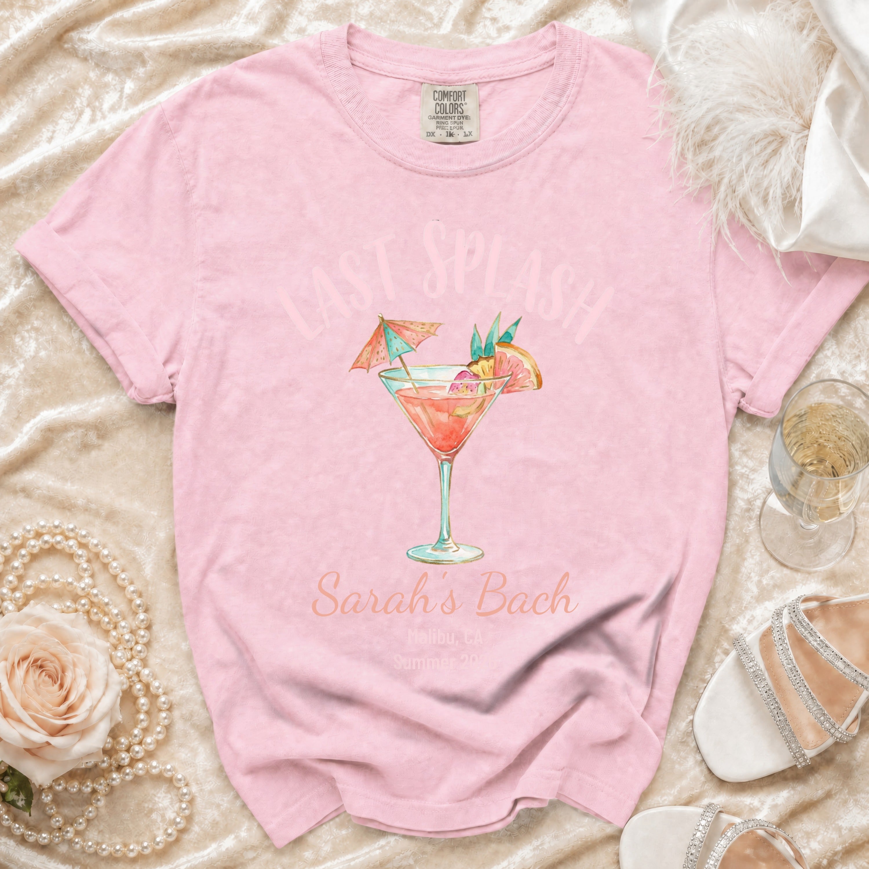 Pink t-shirt with "Last Splash Sarah's Bach" and cocktail graphic.