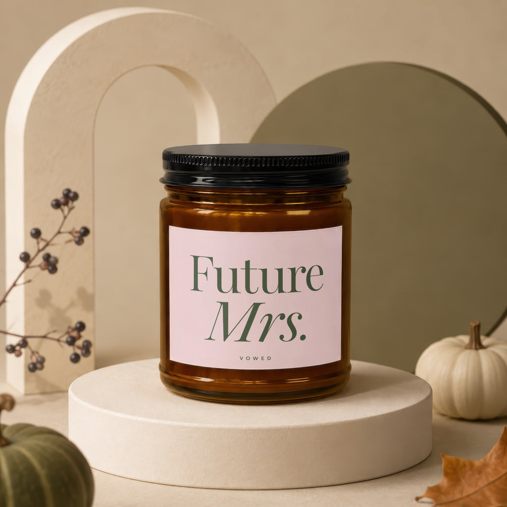 Candle labeled "Future Mrs." with the word "vowed" below, on a pedestal.