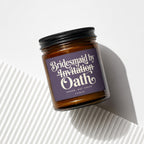 Amber glass candle with a purple label reading "Bridesmaid by Invitation Oath".