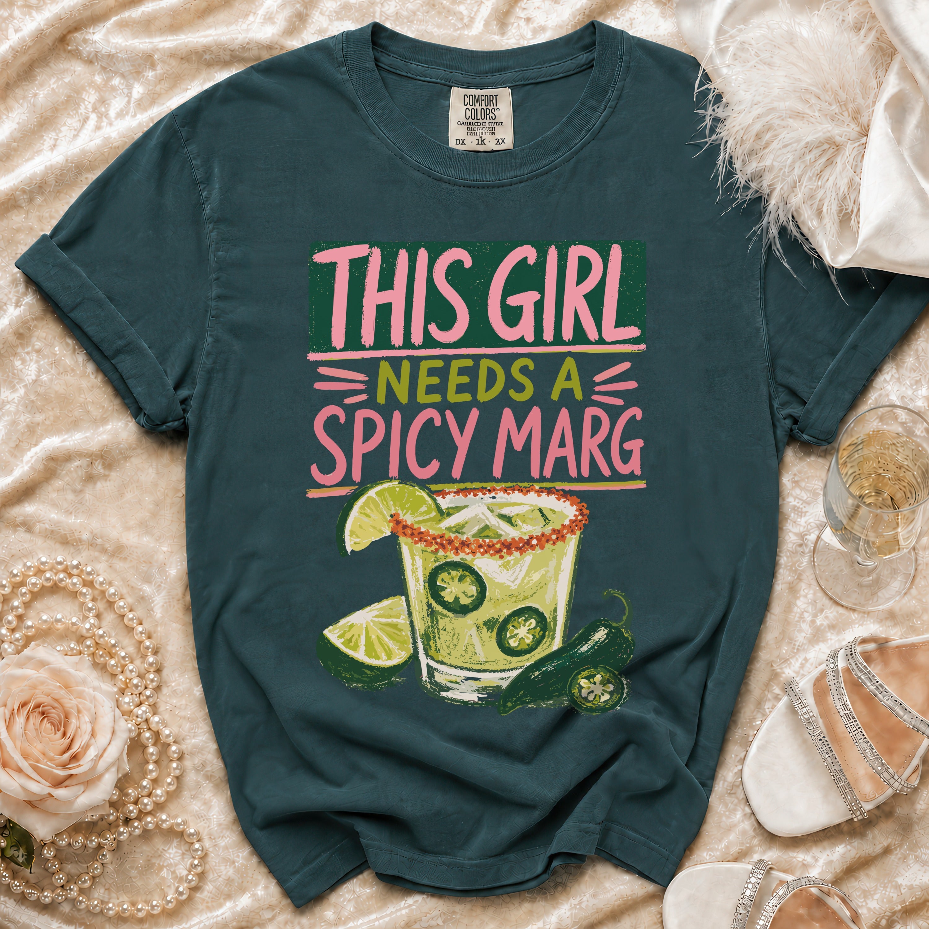Teal t-shirt with "This Girl Needs a Spicy Marg" text and spicy margarita graphic.
