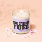 Lit candle in jar that reads "Maid of Honor Fuel" with "VOWED" below.