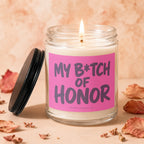 Burning candle with pink label reading "MY B*TCH OF HONOR" and "VOWED CANDLE CO."