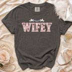 Dark grey t-shirt with "WIFEY" in pink floral letters and two doves.