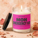 Candle with "MOH EMERGENCY KIT" on a pink label, lid off.