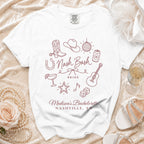White t-shirt featuring a maroon bachelorette design with western icons, Nashville text, and pearls nearby.
