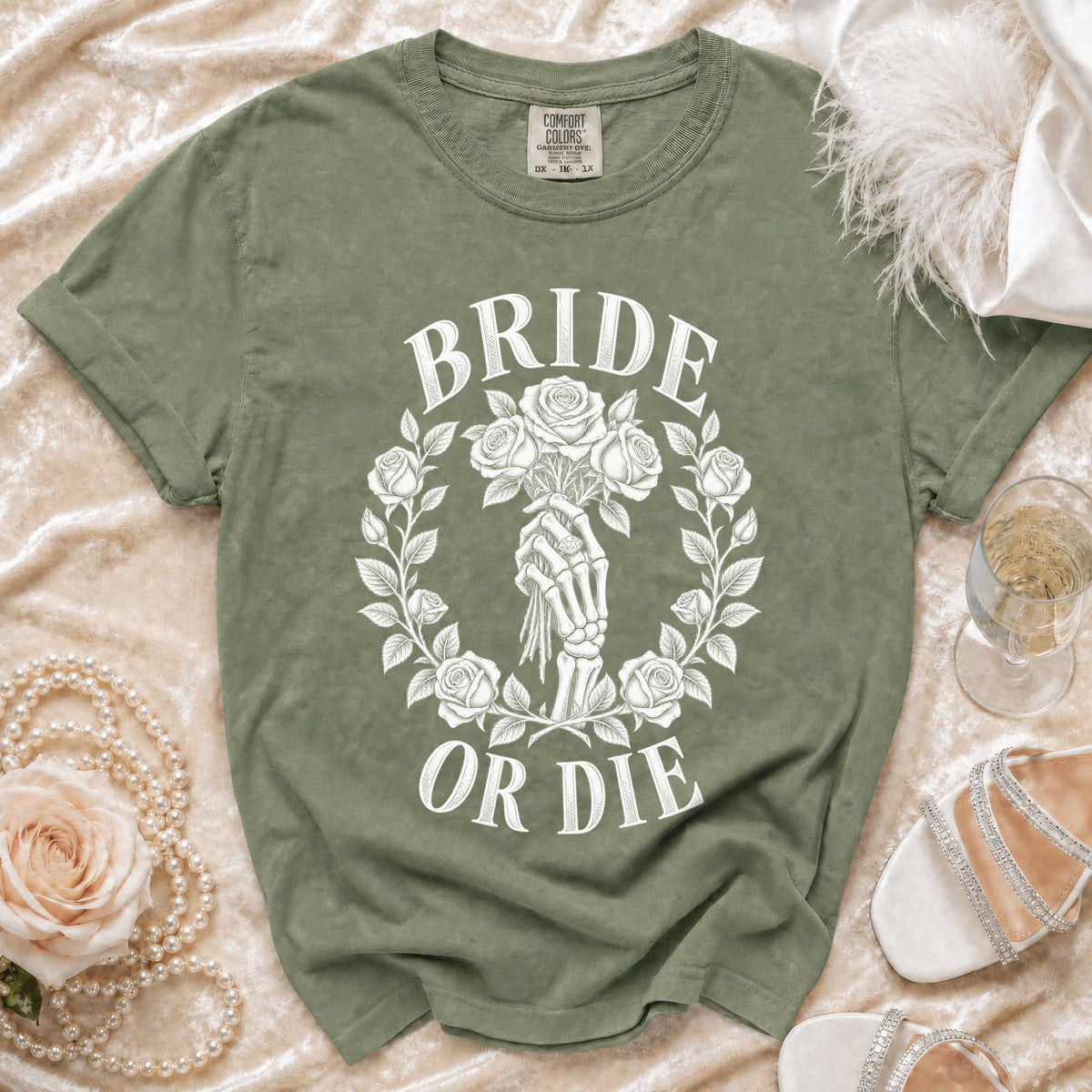Green t-shirt with "BRIDE OR DIE" text and skeleton hand holding roses design.