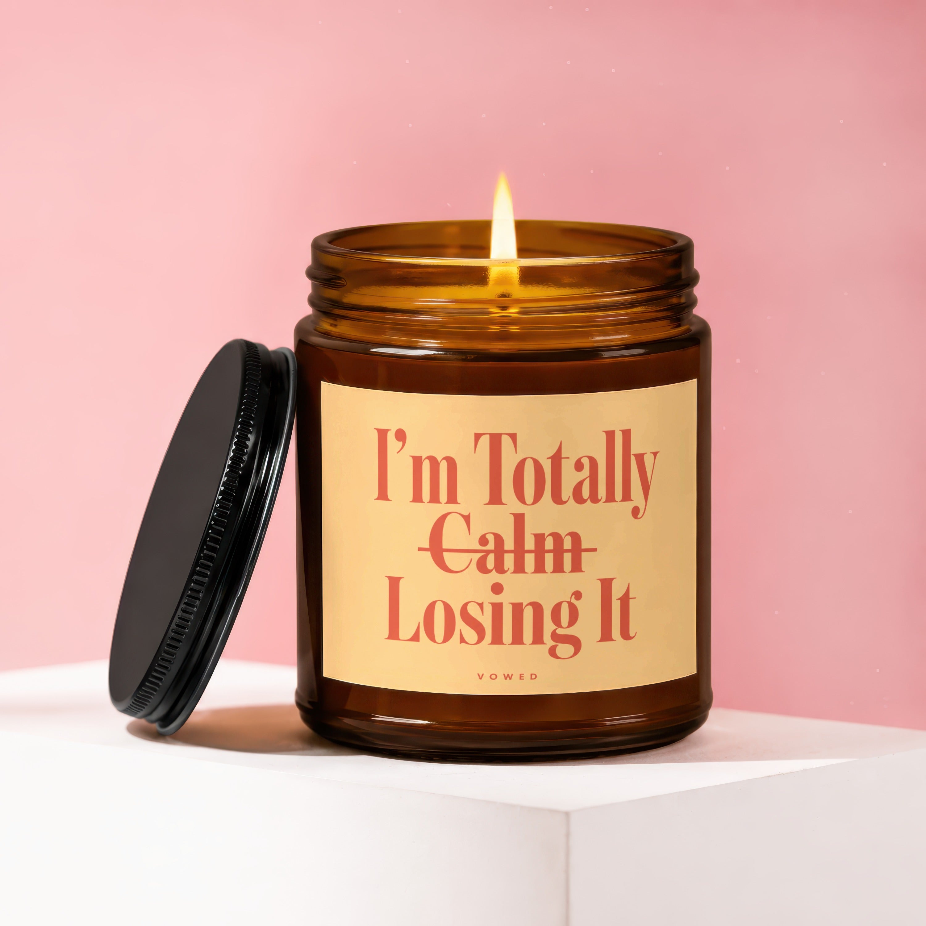 Amber jar candle with lit wick and black lid, reads "I'm Totally Calm Losing It."