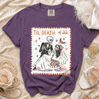 Purple t-shirt with skeleton bride and groom graphic saying "TIL DEATH €22".