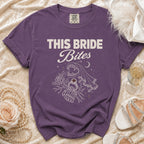 Purple t-shirt with "THIS BRIDE Bites" text and vampire-themed graphic.