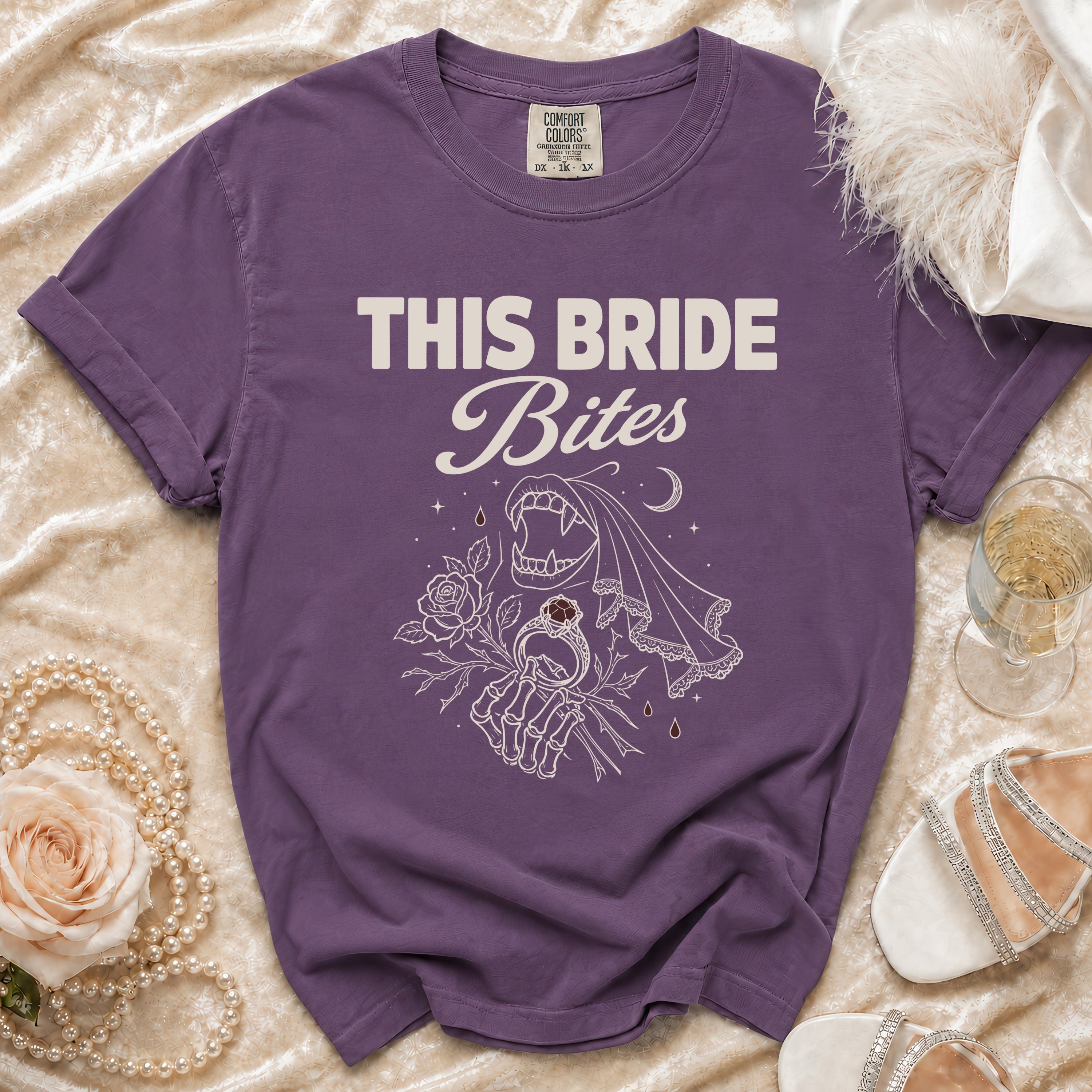 Purple t-shirt with "THIS BRIDE Bites" text and vampire-themed graphic.