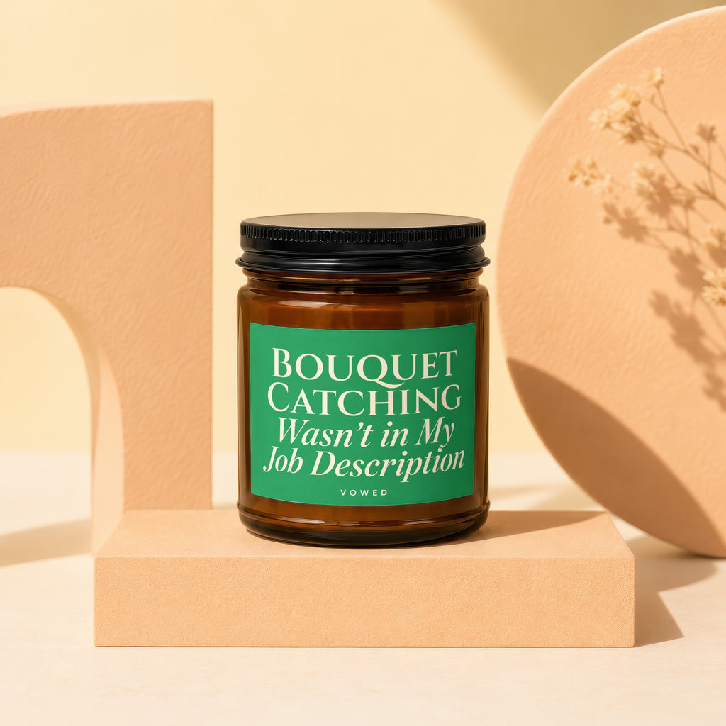 Brown candle with green label reading "BOUQUET CATCHING Wasn't in My Job Description".