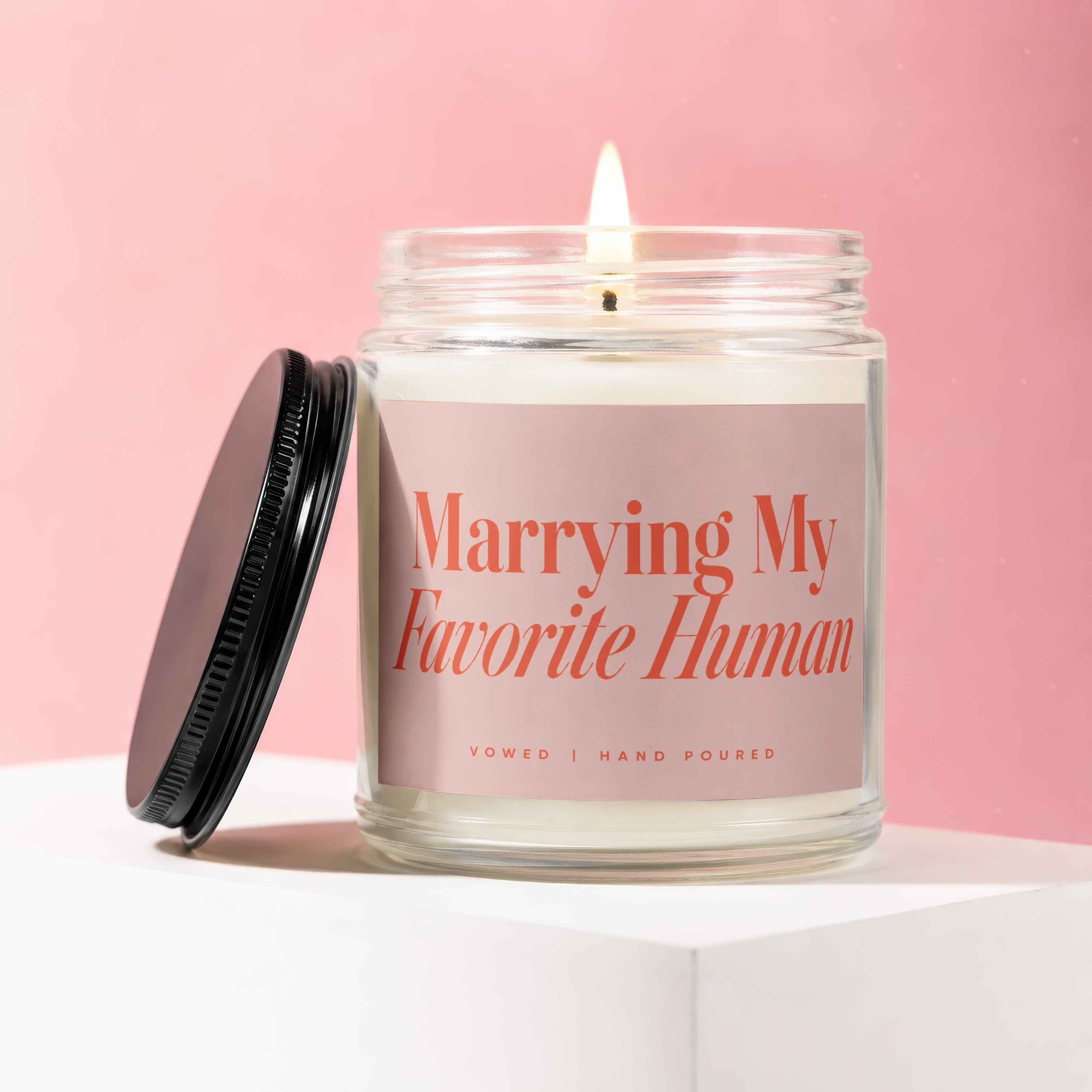 Candle with pink label reading "Marrying My Favorite Human," Vowed, Hand Poured.