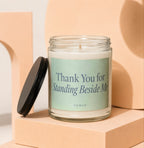 Glass candle with "Thank You for Standing Beside Me" text on label and black lid.