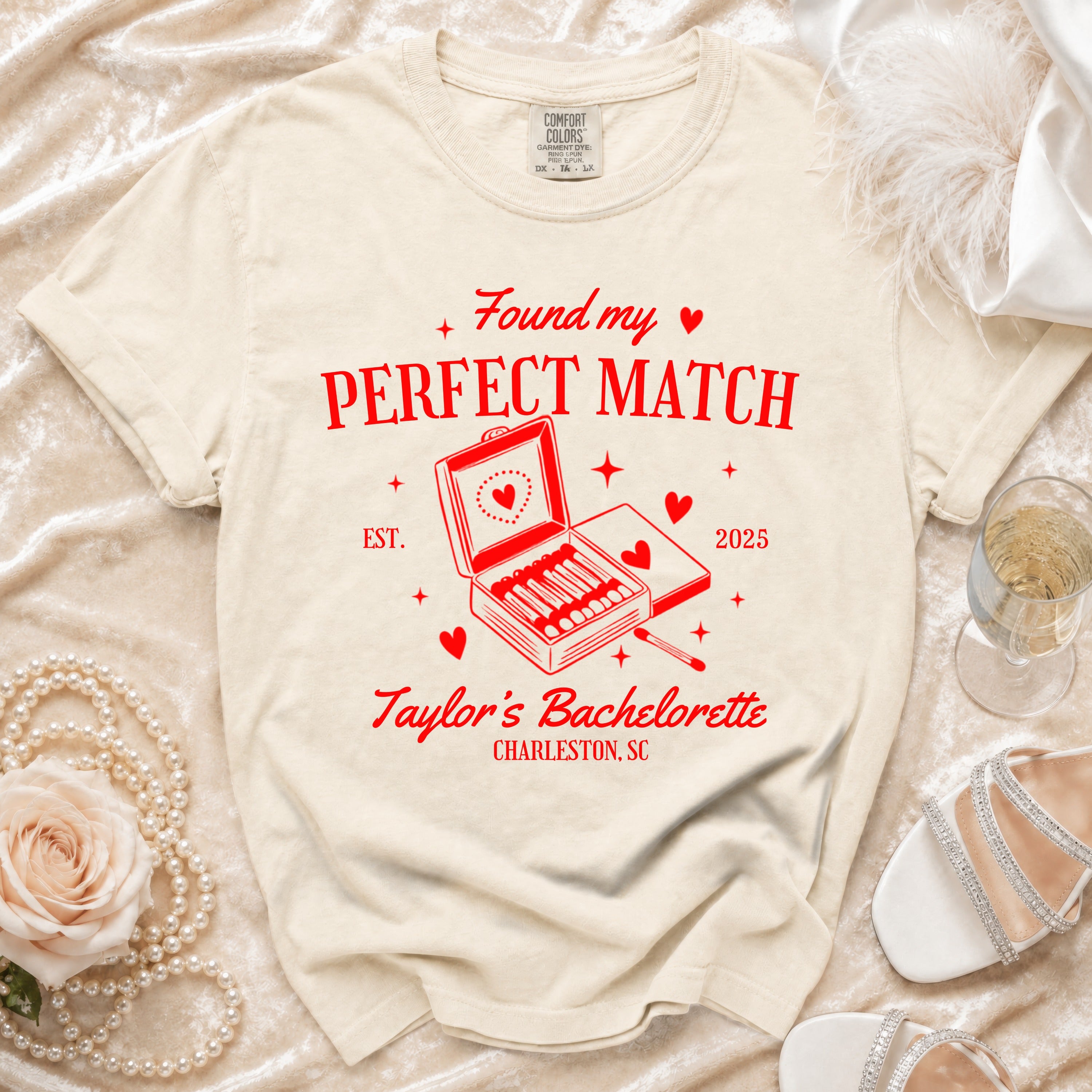 Cream t-shirt with red text and graphic: "Found my PERFECT MATCH EST. 2025 Taylor's Bachelorette Charleston, SC".